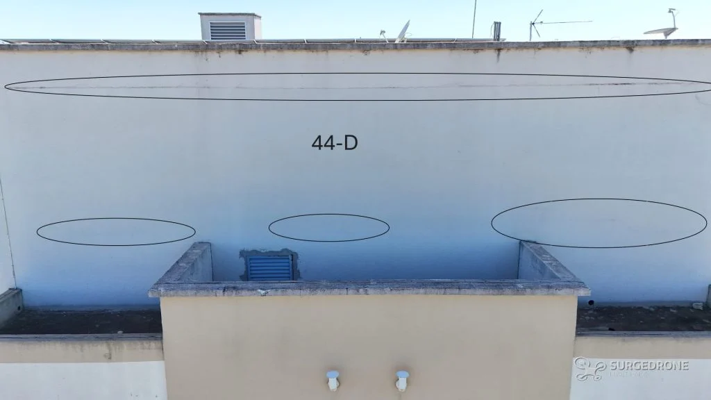 Platibanda com fissuras marcadas em inspeção predial com drone